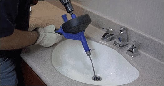 Snaking a clogged kitchen drain.