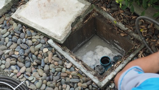 Plumber repairing clogged drain