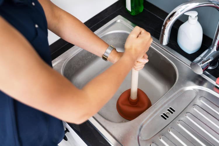 Plunger clearing a clog