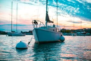 Sailboat at anchor in a Quebec marina at dusk, ready for spring launch