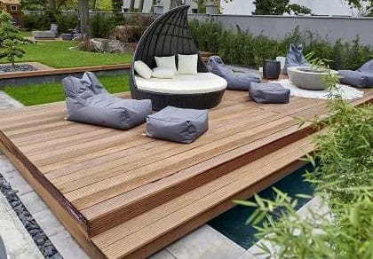Piscina interrata con sofisticato ambiente wellness, dotata di area lounge in legno e lettini prendisole. Perfetta per momenti di relax e divertimento immersi nel verde.