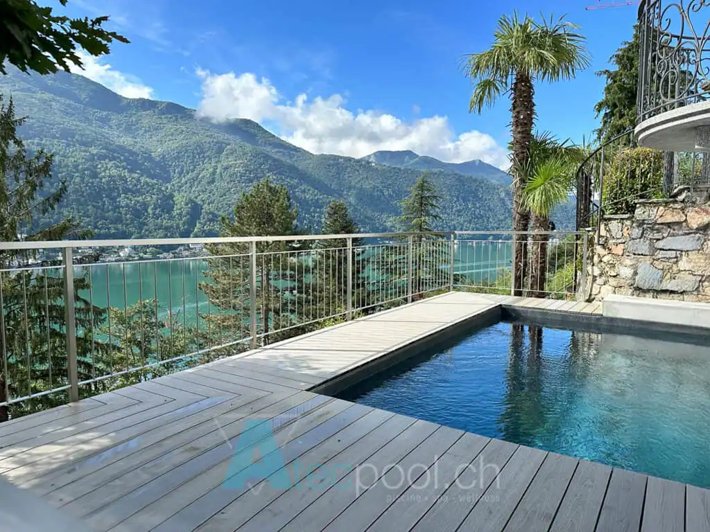 Piscina interrata con vista panoramica sul lago e sulle montagne in Ticino.