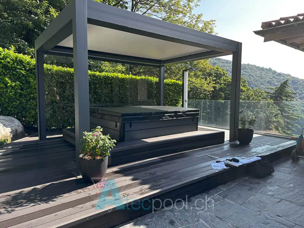 Relaxing outdoor jacuzzi on a wooden terrace under a modern pergola, surrounded by lush greenery and scenic mountain views, perfect for wellness and leisure.