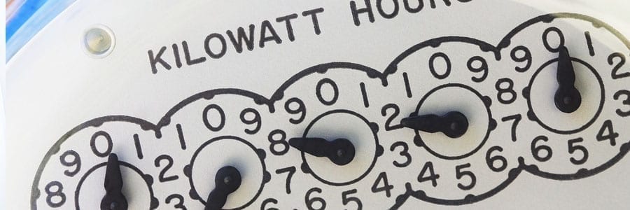 Analog kilowatt-hour meter displaying numbers 9-0-1-8-6, indicating electricity usage.