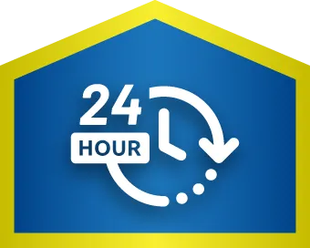 A blue and yellow sign displays a clock icon with an arrow and the text "24 HOUR," indicating 24-hour service or availability.