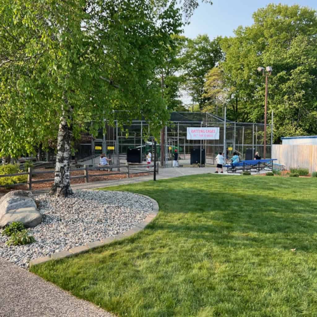 Outdoor park with tennis courts and green spaces.