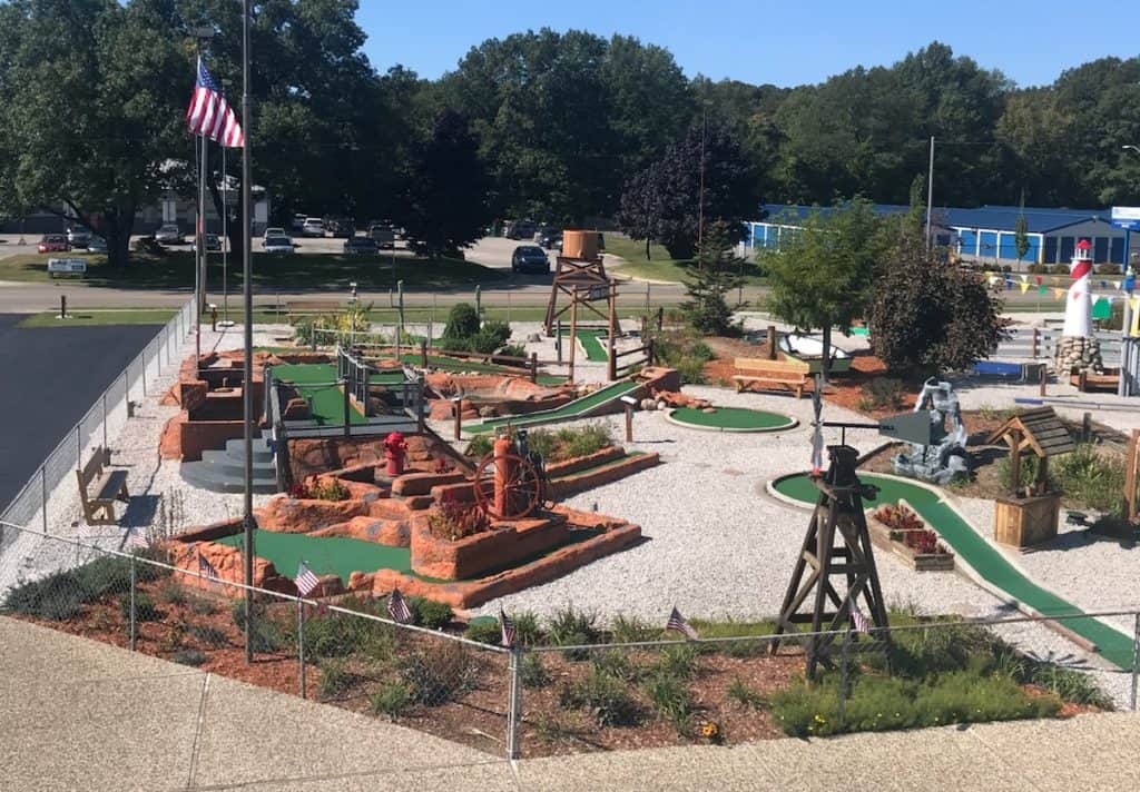Miniature golf course featuring themed obstacles and vibrant landscaping.