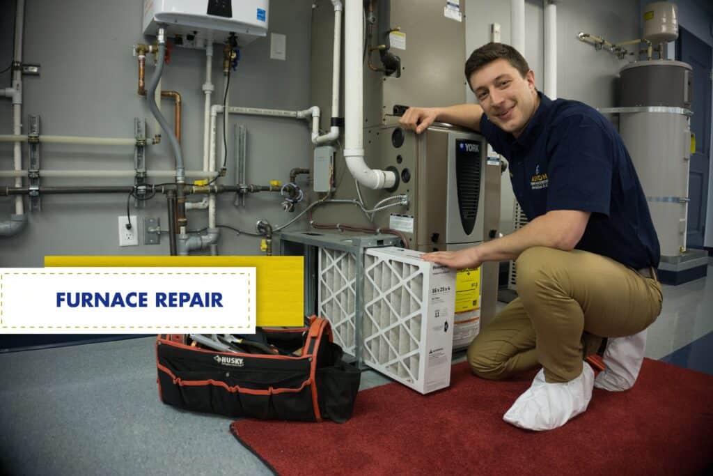 A technician kneels next to a furnace and holds an air filter, with a tool bag and sign reading "FURNACE REPAIR" nearby.