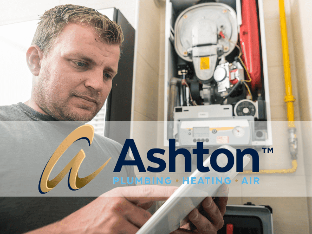 A technician examines a tablet in front of an open HVAC unit, with the Ashton Plumbing, Heating, Air logo overlaid on the image.