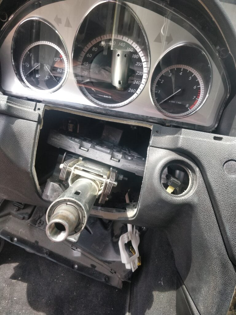 Broken car dashboard with exposed steering column, automotive repair, locksmith, auto locksmith, vehicle ignition service.