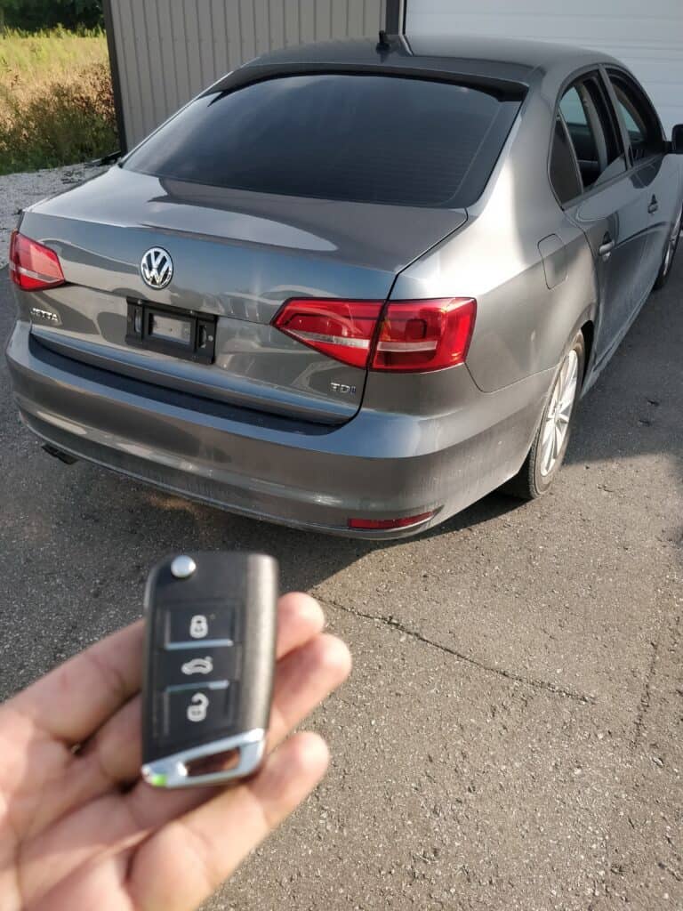 Remote car key fob for Volkswagen, offering locksmith services for vehicle key replacement and programming.