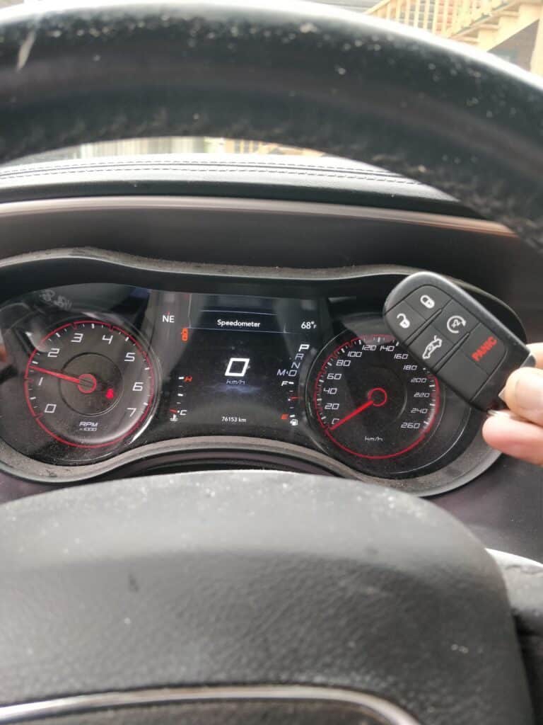 Key fob with lock, unlock, panic buttons for vehicle security and remote access.