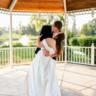 bride and groom kissing after being married