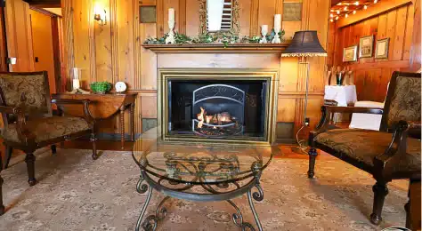 Warm fireplace in a rustic living room at Cascades Manor.