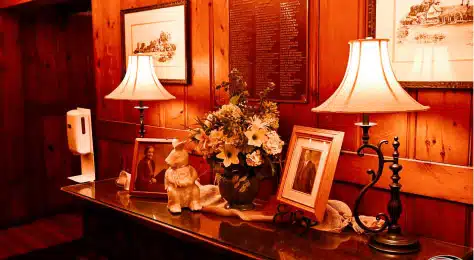 Cozy interior with lamps, flowers, and framed photos at Cascades Manor.