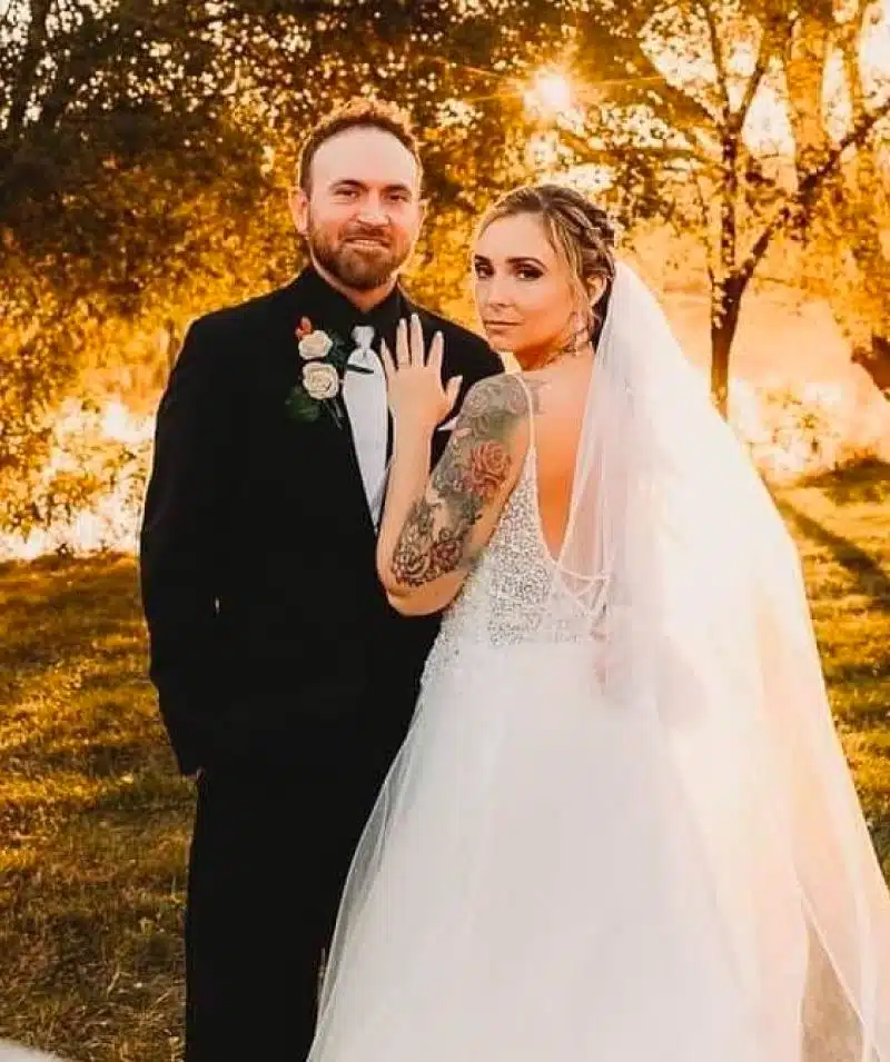 Wedding couple at Cascades Manor with sunset background, celebrating love and union.