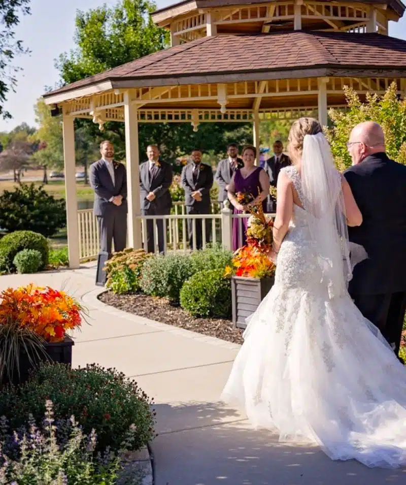 Elegant outdoor wedding ceremony at Cascades Manor with bride, groom, and wedding party.