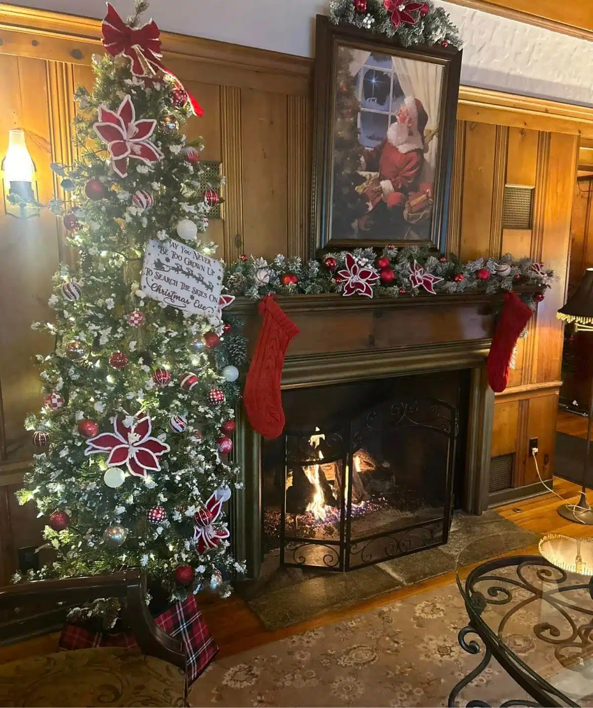 Christmas fireplace with decorated tree and stockings at Cascades Manor.