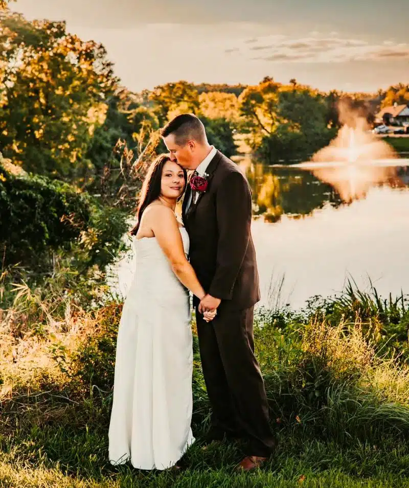 Beautiful wedding couple at Cascades Manor by the lake at sunset.