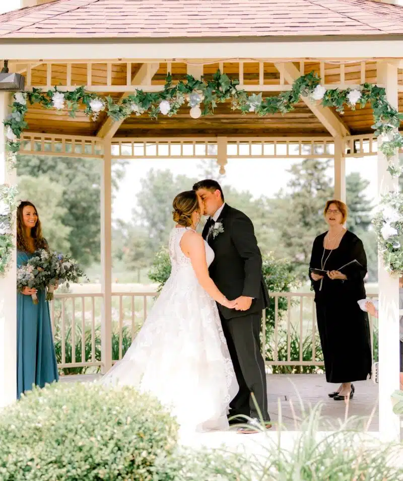 Wedding ceremony at Cascades Manor, outdoor gazebo with lush greenery.