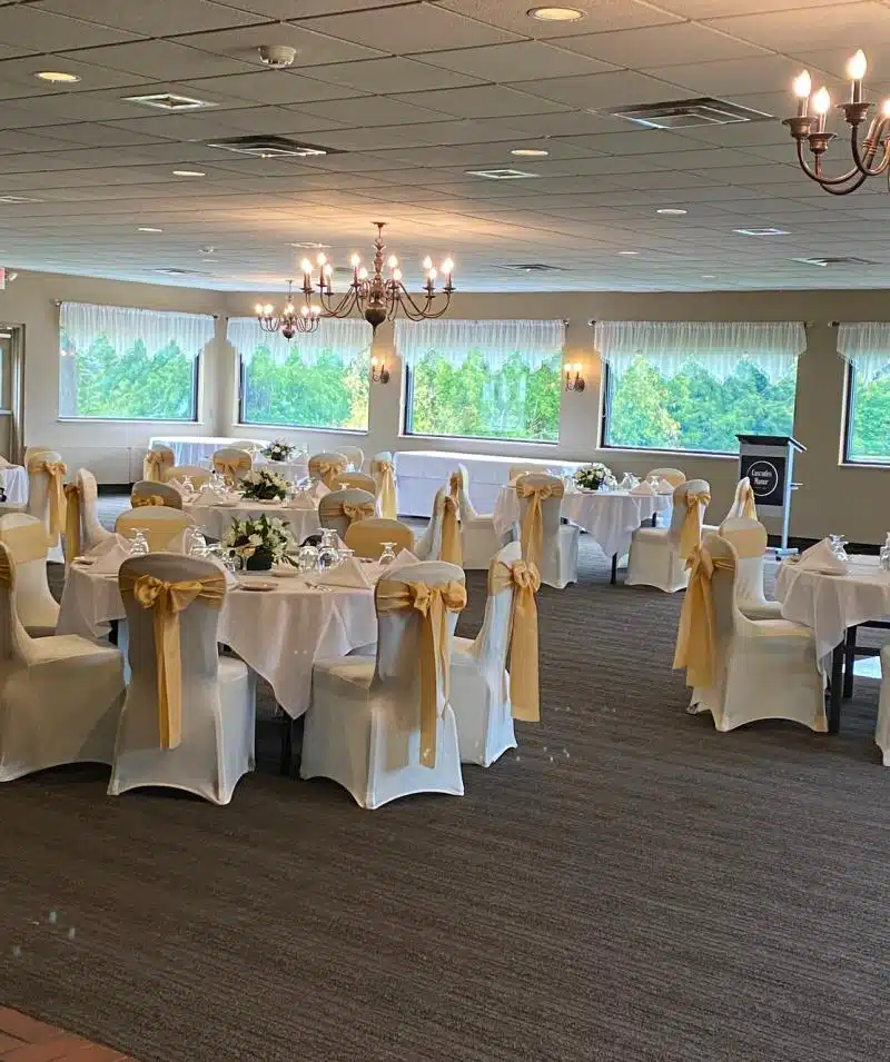 Beautiful indoor event space with large windows and chandeliers.