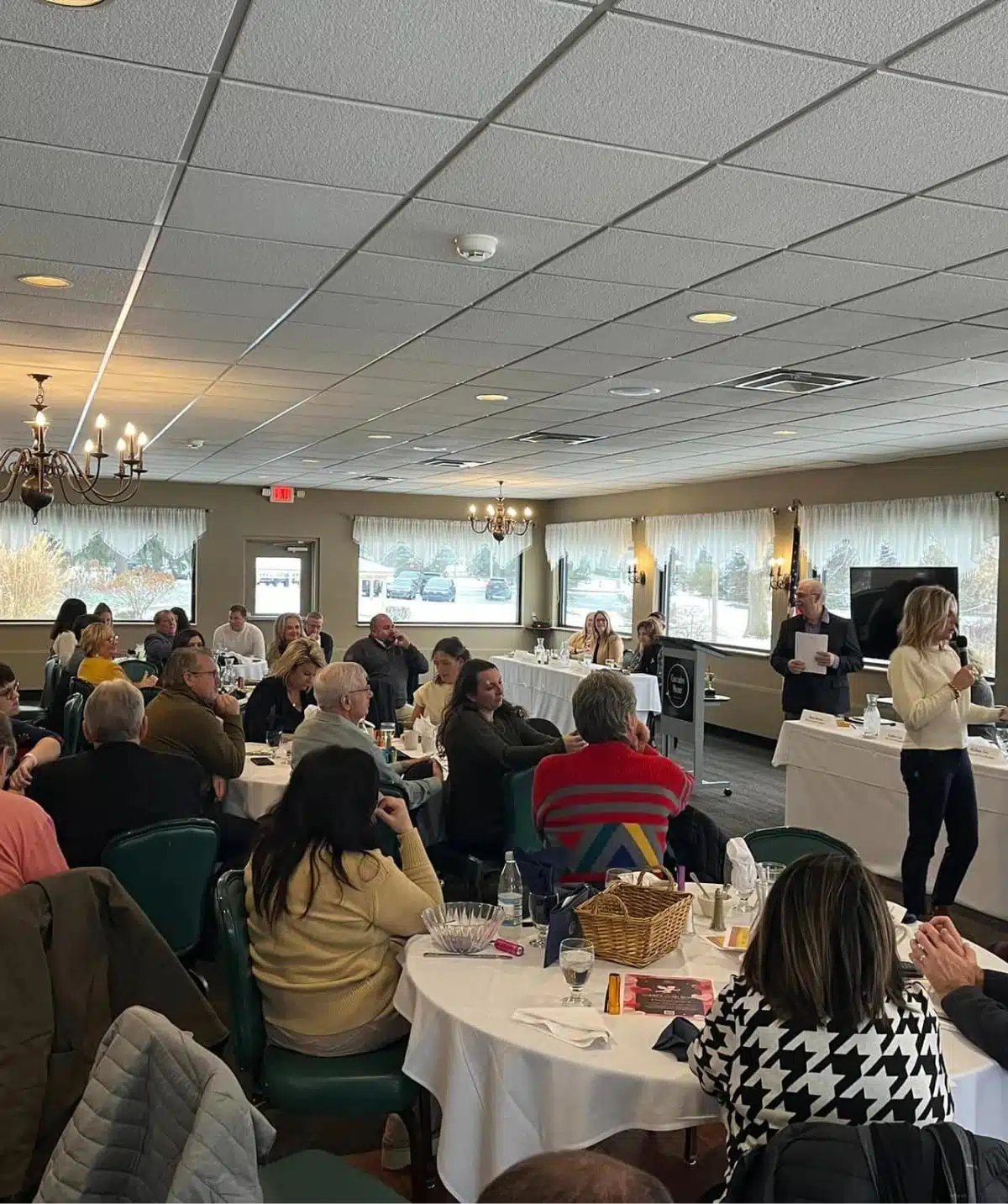 Event gathering at Cascades Manor in a spacious banquet hall.