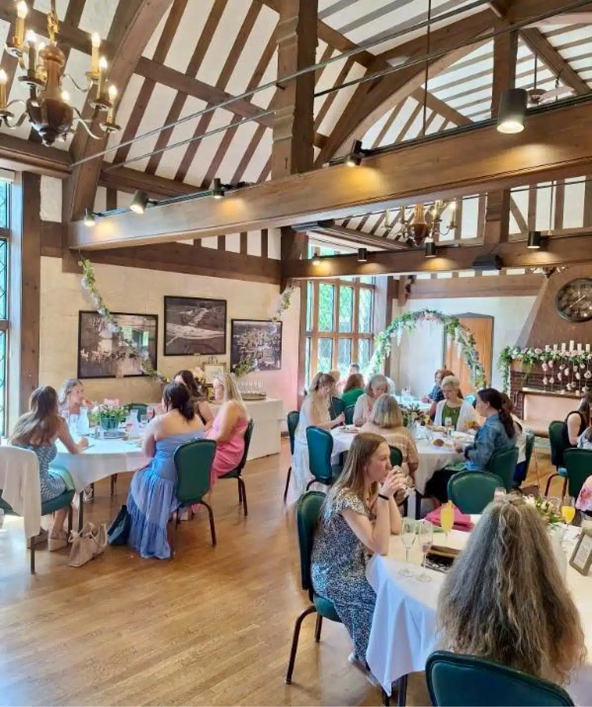 Elegant event space at Cascades Manor with guests enjoying a celebration in a rustic, wooden interio.