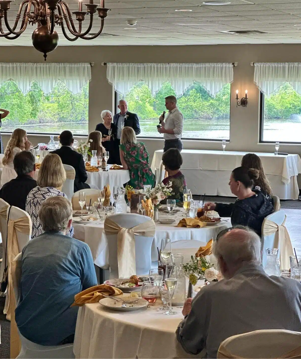 Elegant event at Cascades Manor with guests enjoying a formal gathering by the water.