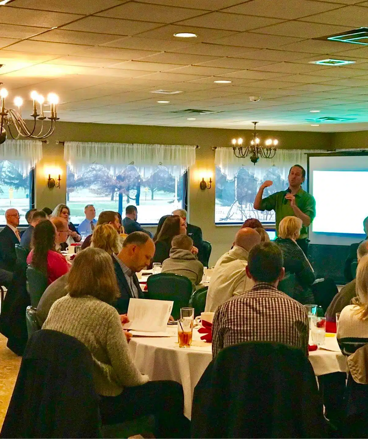 Conference room at Cascades Manor with attendees listening to a speaker.