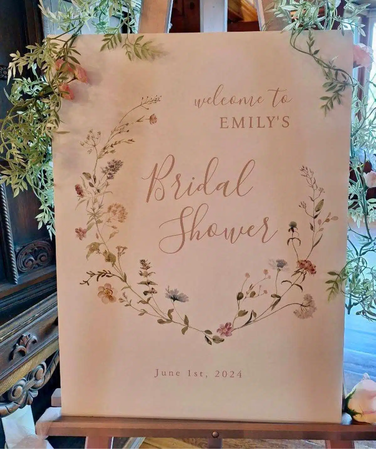 Welcome sign for Emily's bridal shower with floral design at Cascades Manor.
