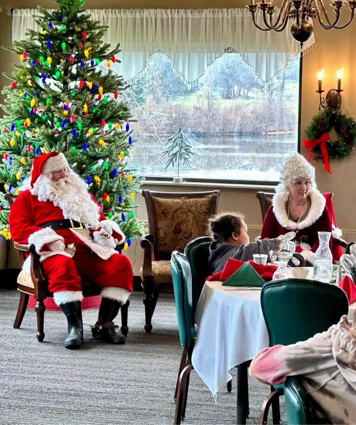 Santa Claus with children during holiday celebration at Cascades Manor.