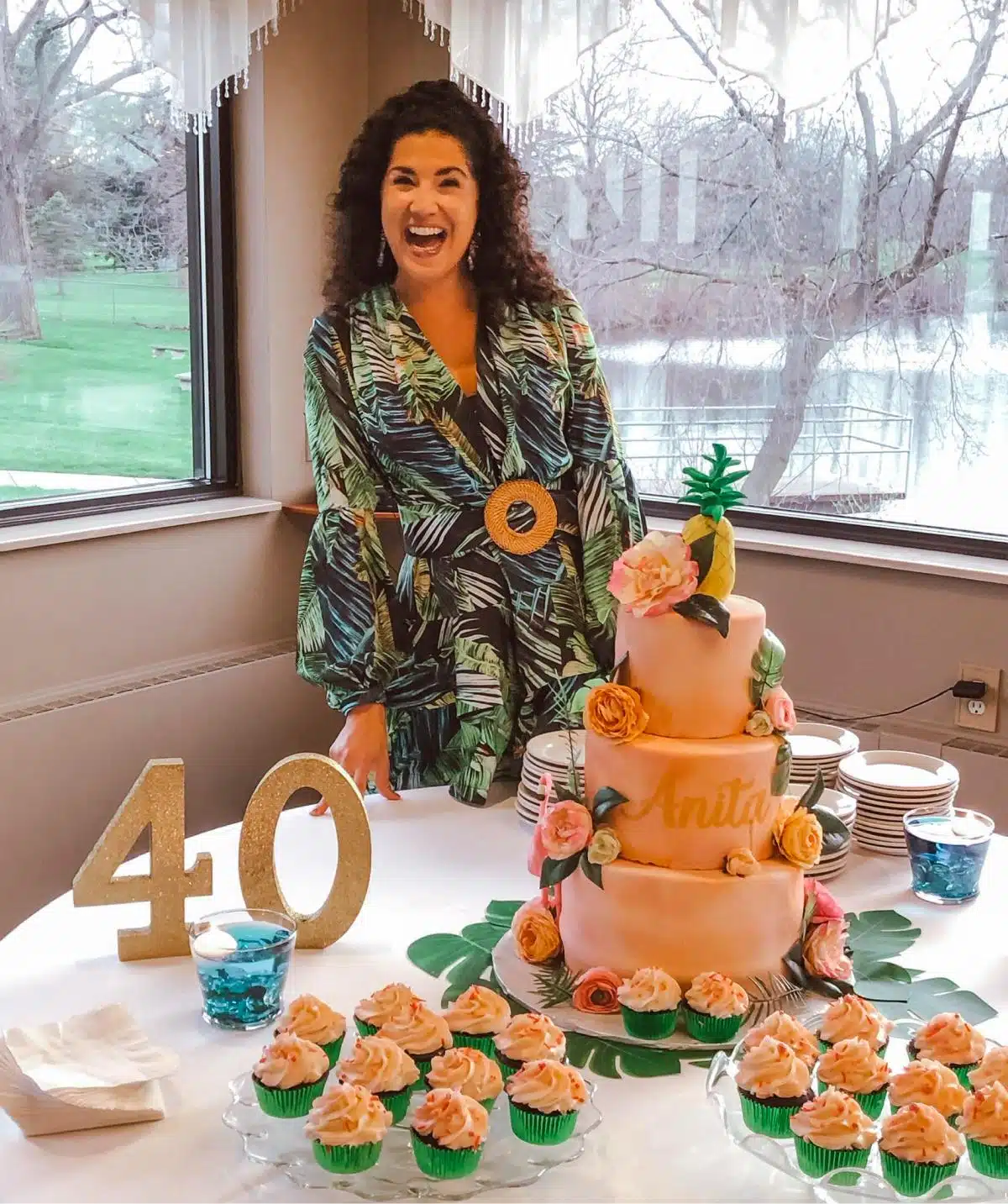 Happy woman with a cake at Cascades Manor, celebrating a 40th birthday event.