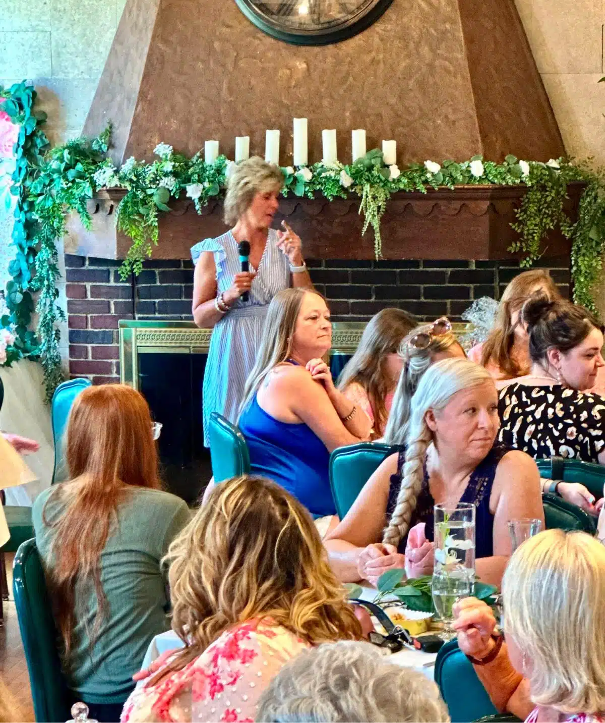 Indoor event at Cascades Manor featuring a woman speaking to seated guests.