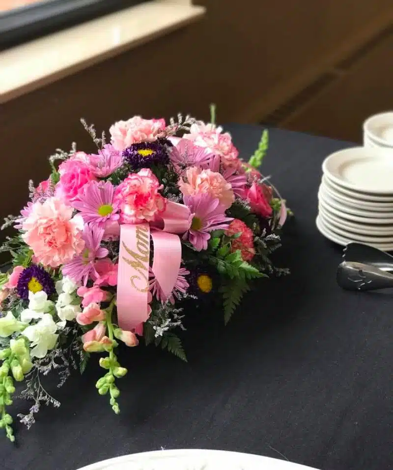 Beautiful pink and purple flower centerpiece for Cascades Manor celebrations.
