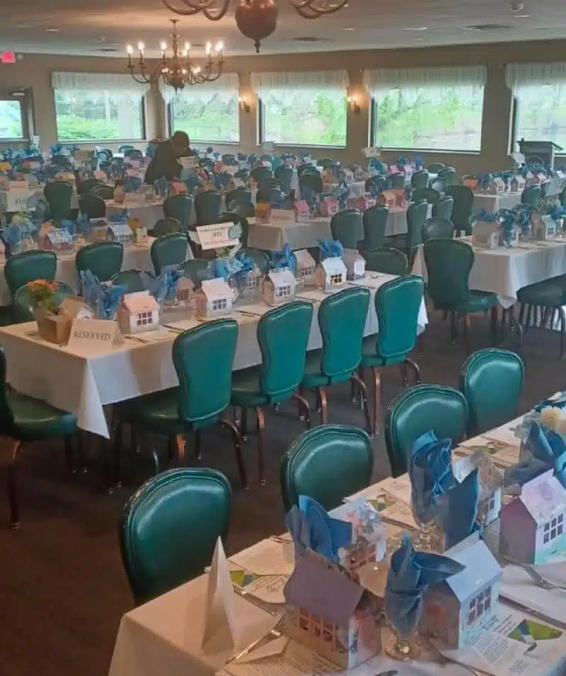small houses with blue napkins on table