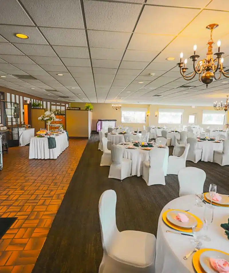 white tables and chairs set up for wedding reception