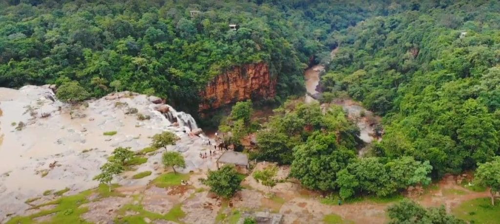 Tirathgarh Waterfall surrounded by lush greenery during post-monsoon season