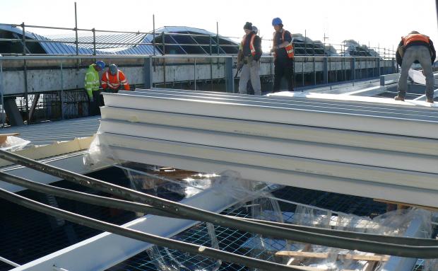 Raise the roof – workers install the new roof at Clacton Pier.
