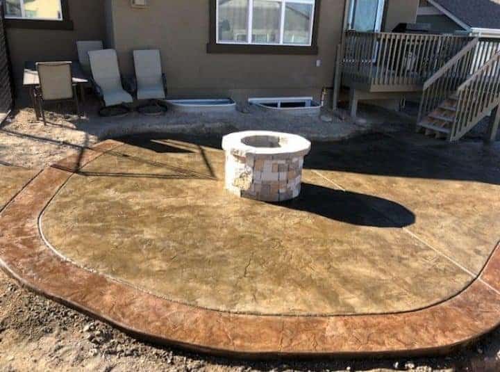 Two-tone stamped concrete patio with integral fire pit and decorative colored border, Colorado Springs