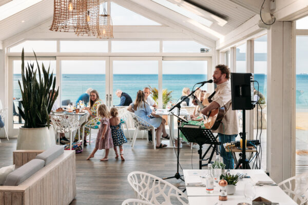 Beachfront restaurant with live music, family dining, and seaside views in Cornwall.