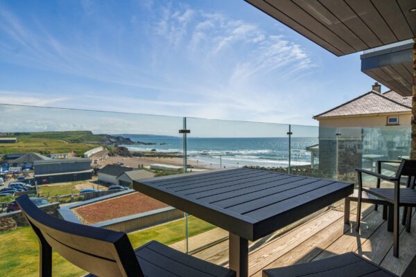 Breathtaking coastal view from a Cornwall seaside accommodation balcony.