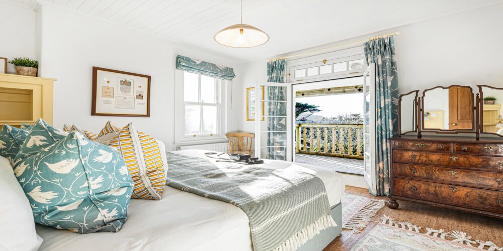 Coastal bedroom with ocean views, Cornwall accommodation, relaxing seaside getaway.
