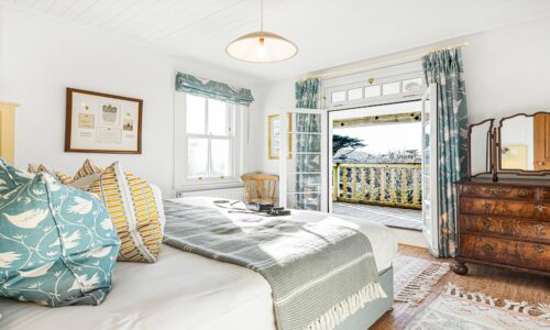 Coastal bedroom with ocean views, Cornwall accommodation, relaxing seaside getaway.