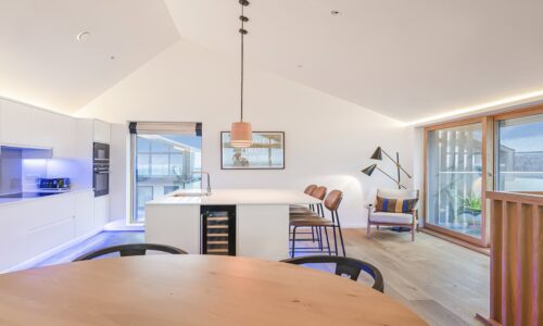 Modern seaside apartment with kitchen and balcony views in Cornwall, perfect for holidays.