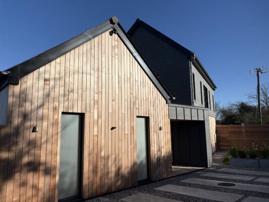 Contemporary Cornwall holiday cottage with modern black and wooden exterior, perfect for relaxing stays.