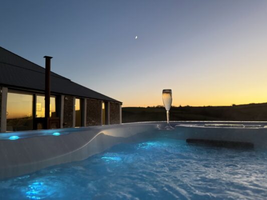Relaxing hot tub with sunset views at Cornish Secrets.