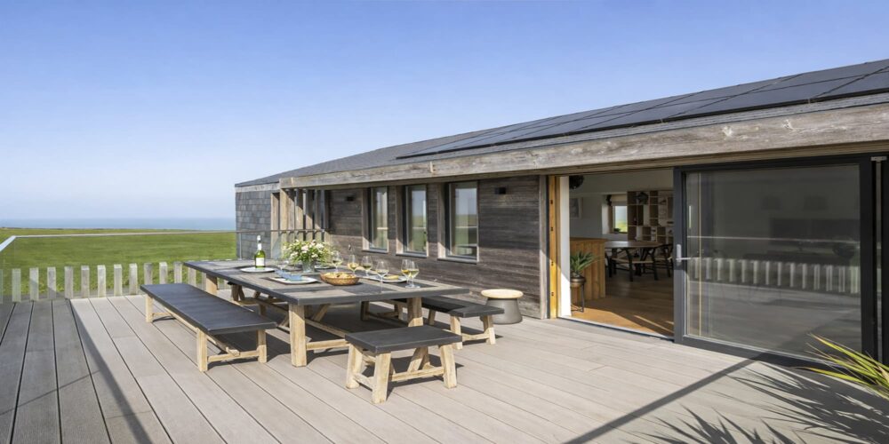 Modern coastal holiday home with outdoor dining area in Cornwall.