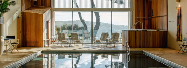 Relaxing spa lounge with panoramic sea views and indoor pool.
