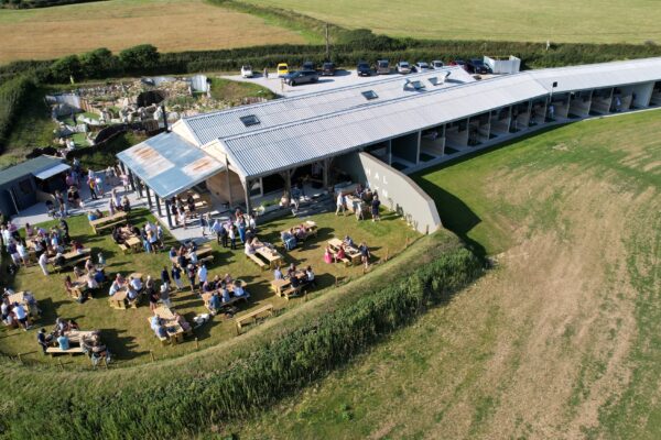 Outdoor event at Cornish Secrets Halwyn with guests enjoying food and drinks.