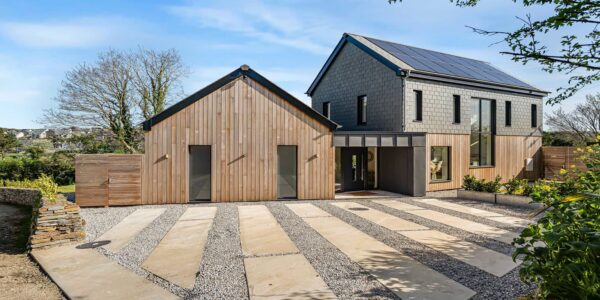 Cornish Secrets coastal retreat with modern and rustic design, solar panels, and landscaped garden.